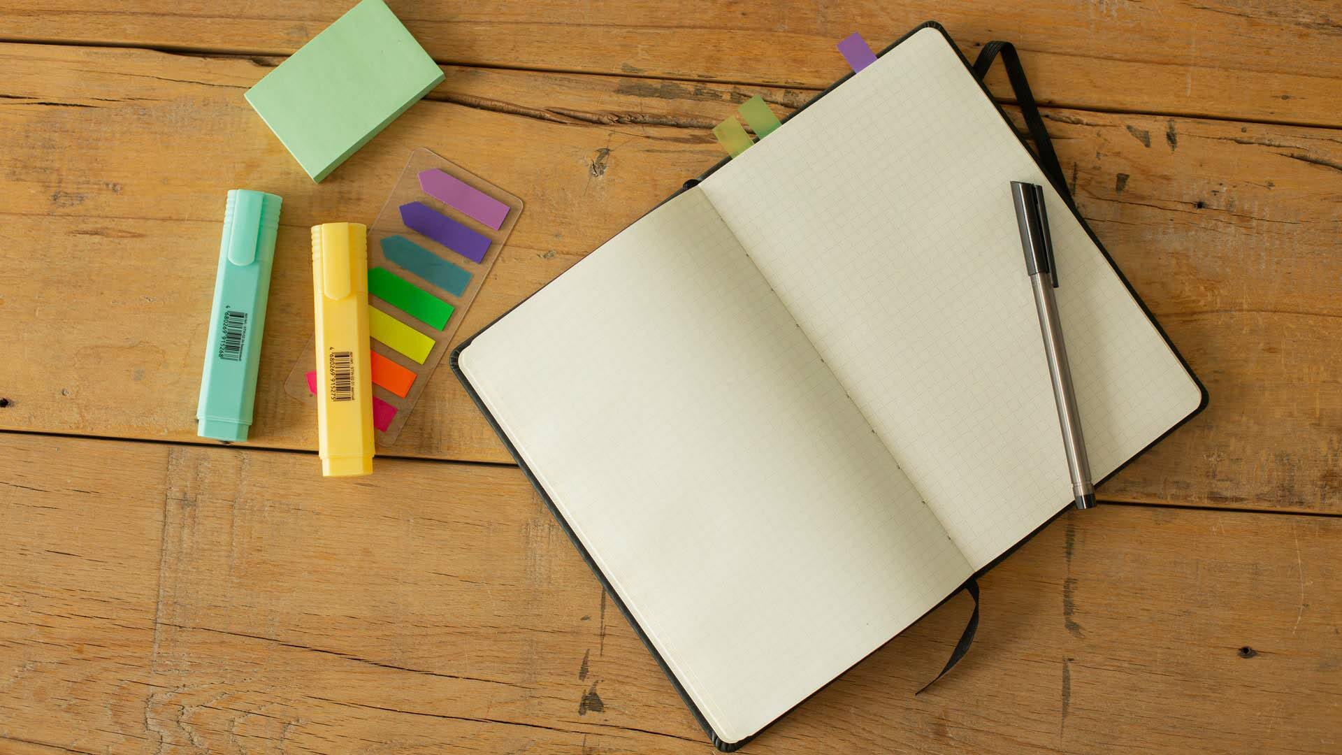 Photo of a notepad and pen with stationery